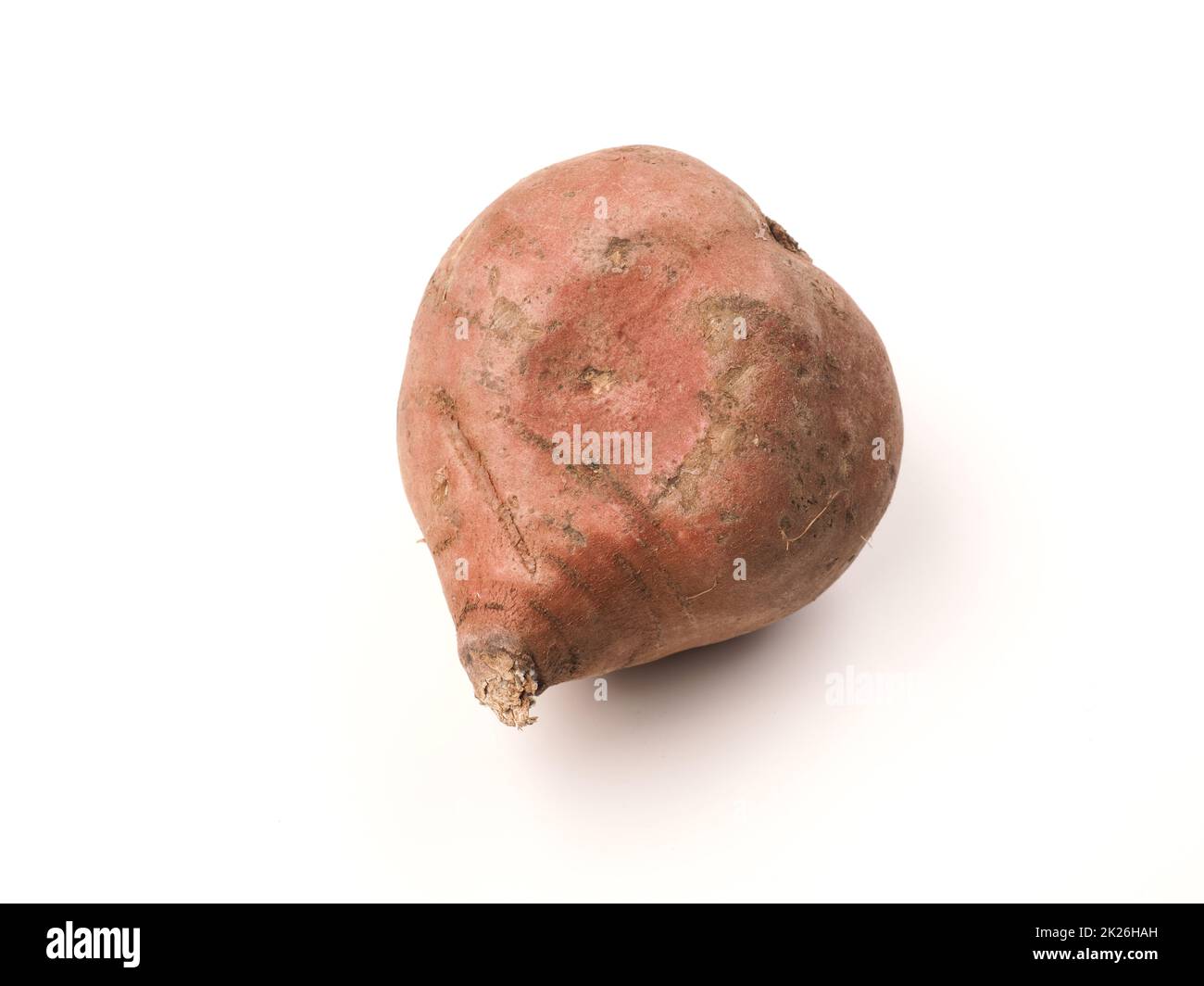 A heart shaped sweet potato on a white studio background Stock Photo
