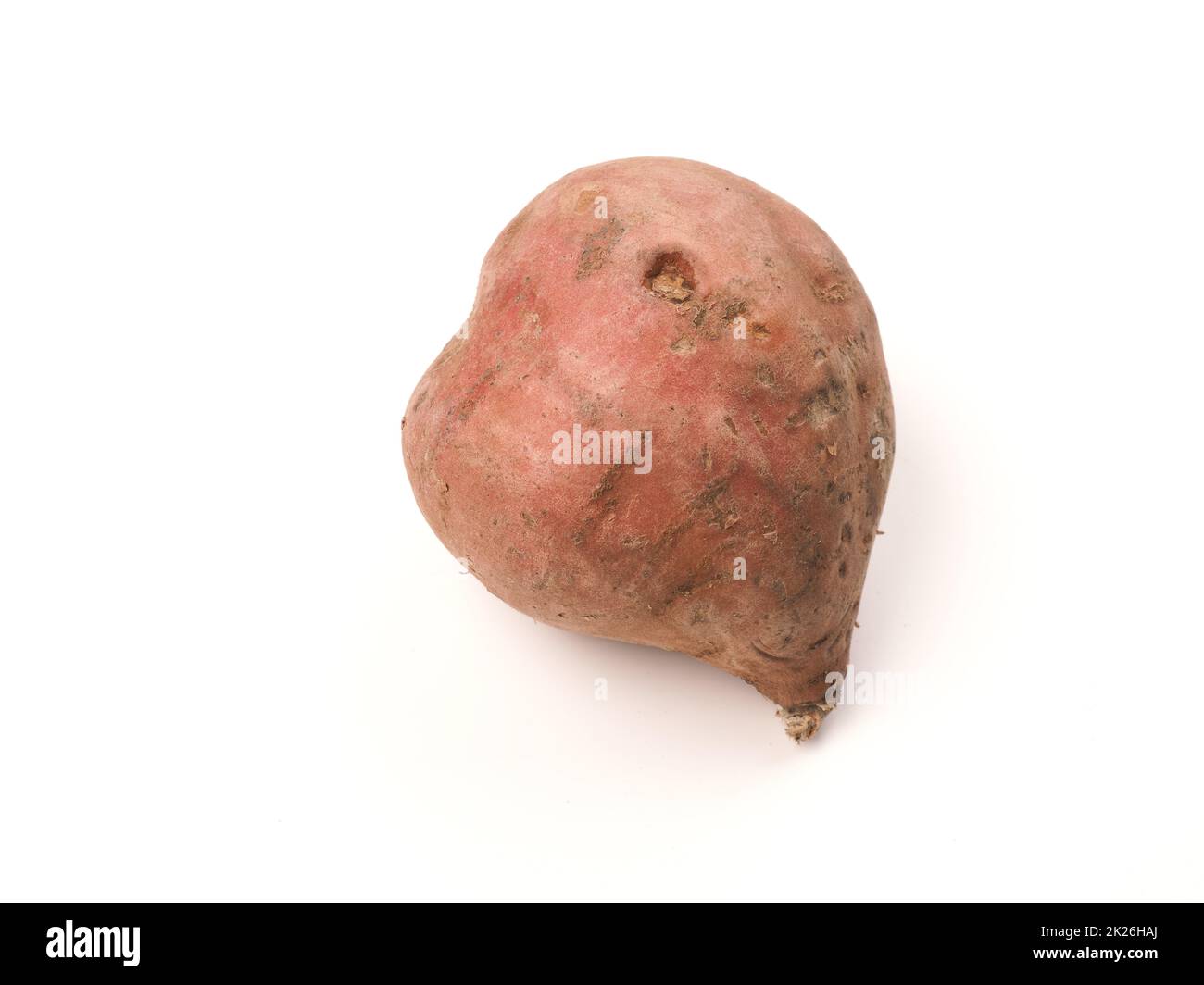 A heart shaped sweet potato on a white studio background Stock Photo