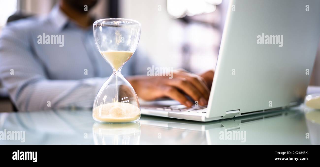 Financial Deadline And Hourglass In Office Stock Photo