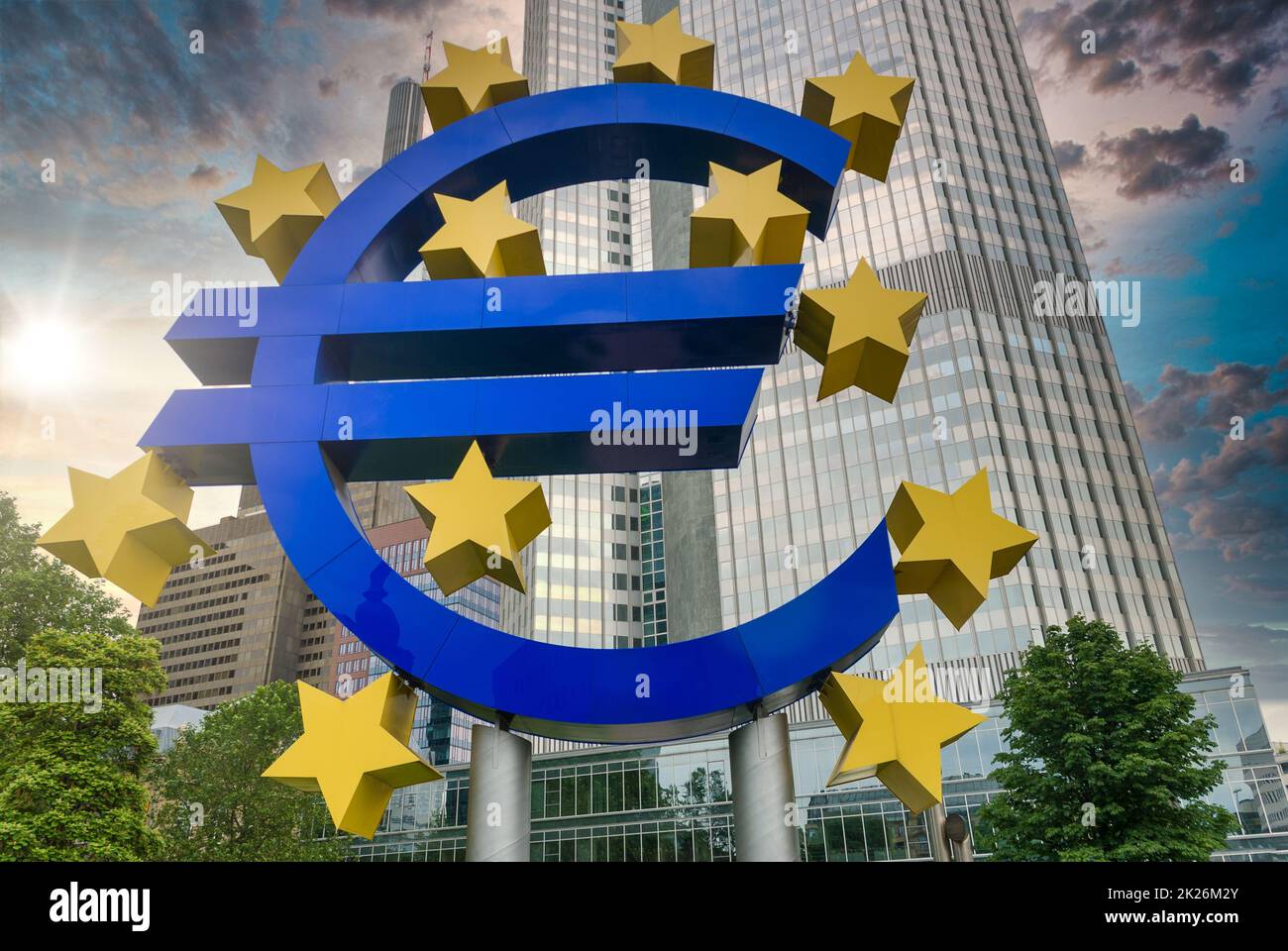 Euro sign at EZB Frankfurt downtown, sunset with flares, view from low angle, Germany Stock Photo