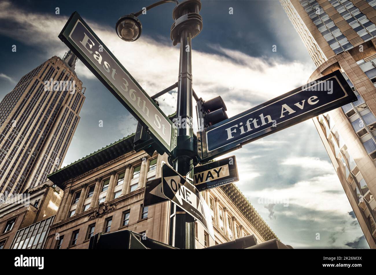 Fifth Ave 5th Ave, New York City sign, view from low angle with sunset