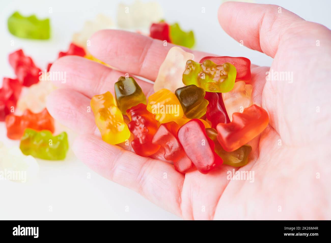 colored gummy bears in an open hand Stock Photo