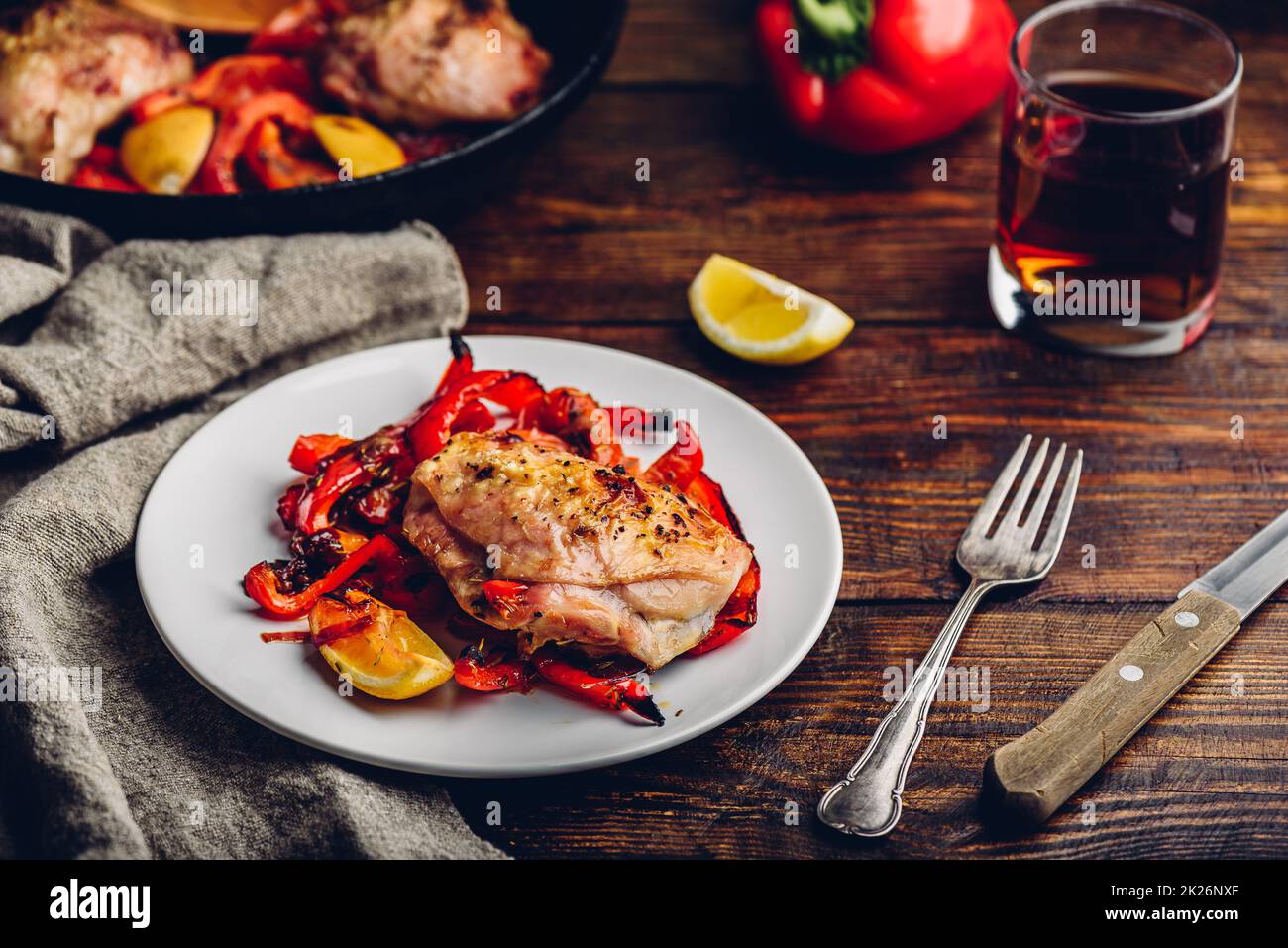 Baked chicken thighs with red bell peppers and lemon Stock Photo Alamy