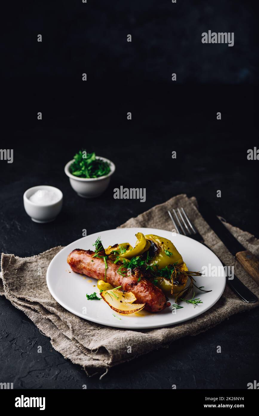 Pork sausage with green bell peppers, onion and herbs Stock Photo