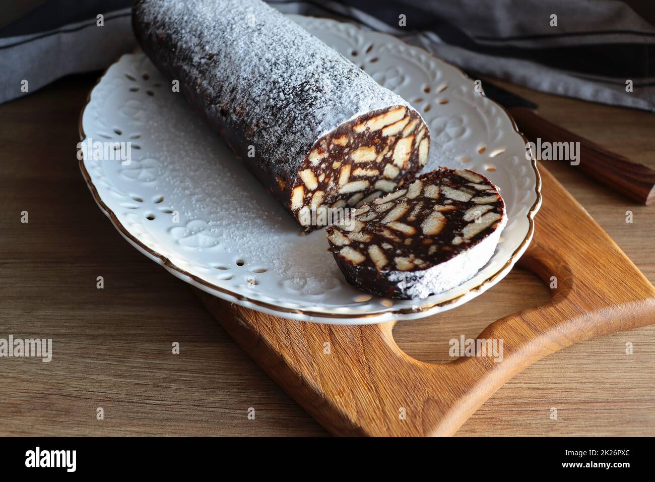 Lazy cake or mosaic cake . Homemade no bake chocolate biscuit cake on a wooden table Stock Photo