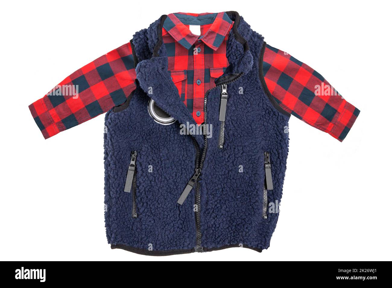 Fur vest. A blue fur vest with blue wool lining fabric and a red checkered shirt for the little boy isolated on a white background. Child spring and autumn fashion. Stock Photo