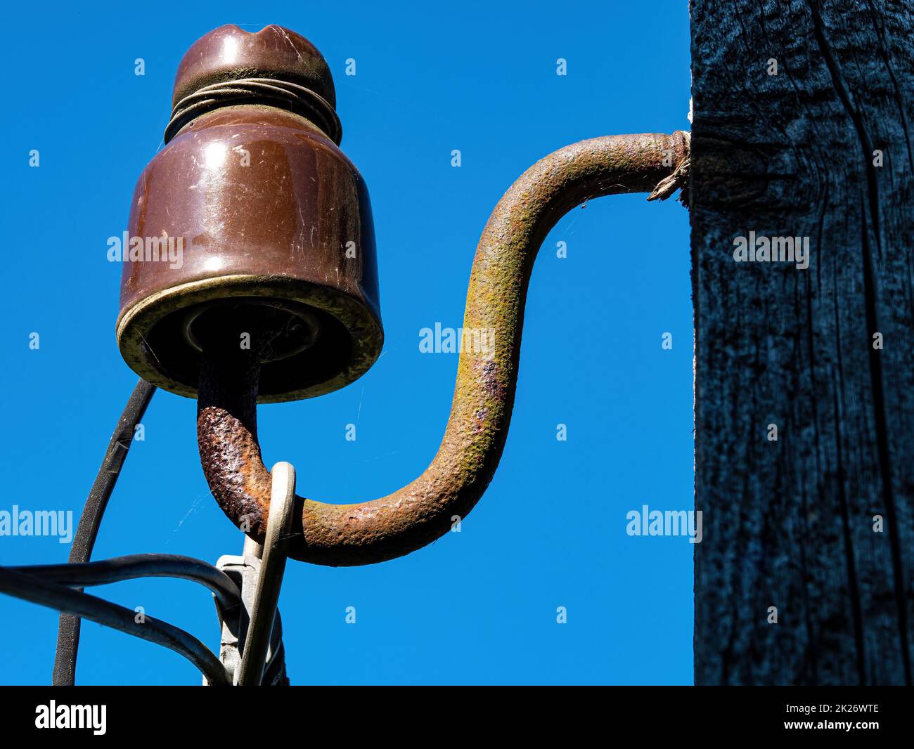 Line insulator for hanging wires and cables on overhead power line supports. Stock Photo