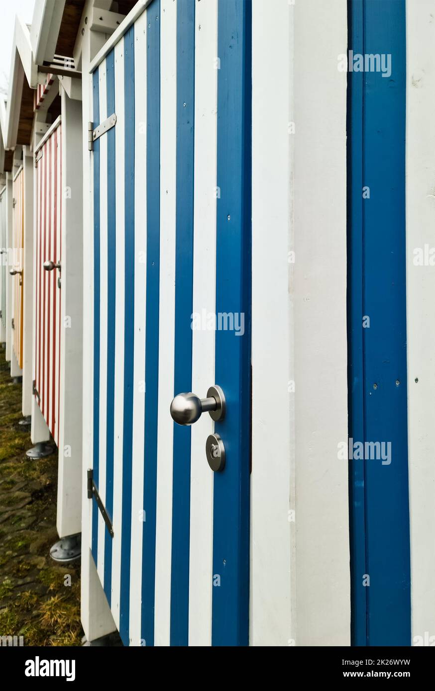 Striped wooden doors of many changing rooms with a strong perspective