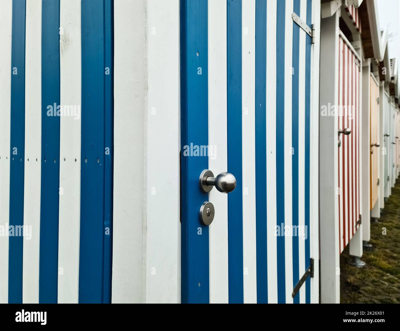 Striped wooden doors of many changing rooms with a strong perspective
