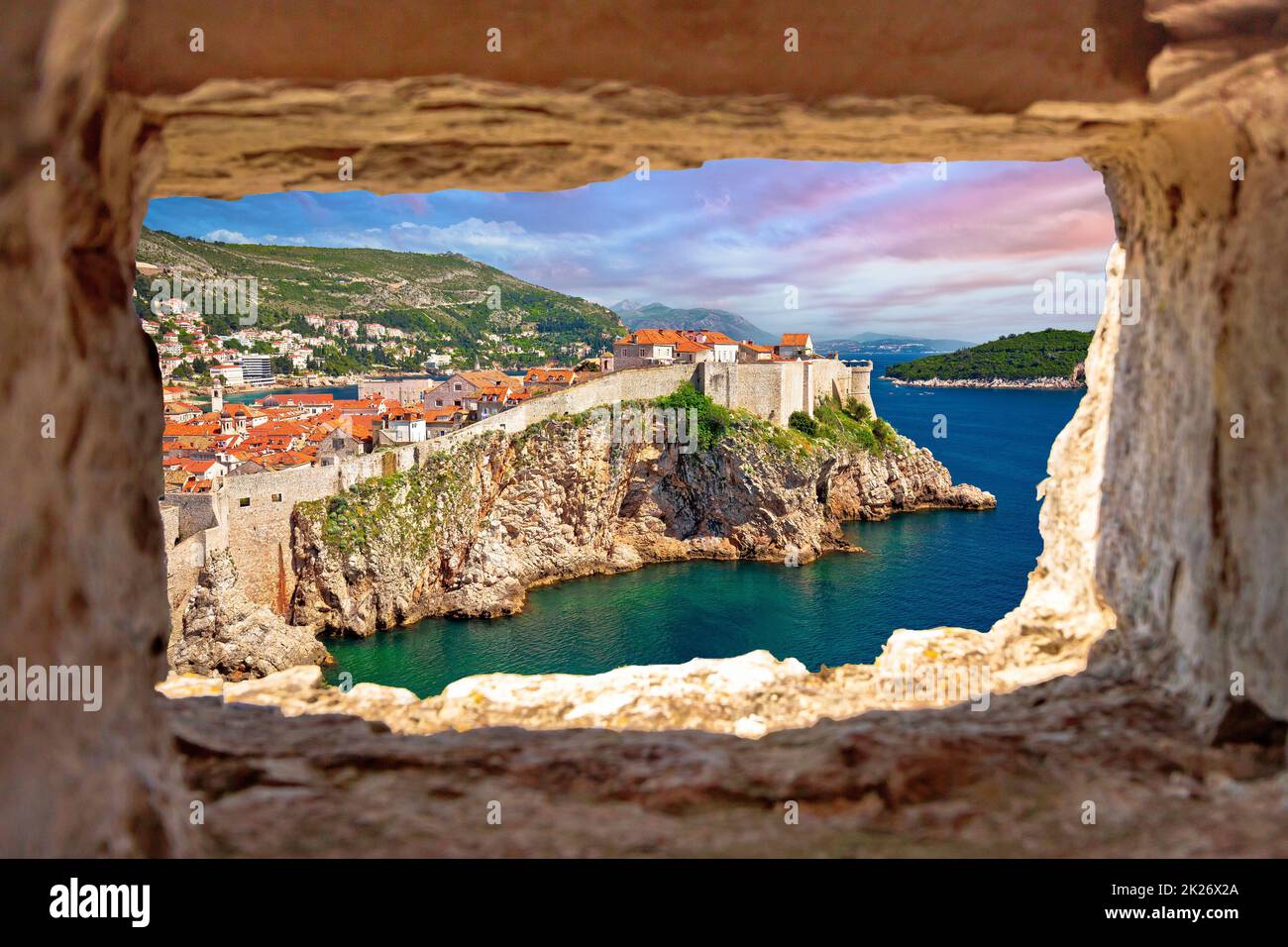 Town of Dubrovnik and defence walls view through stone window Stock Photo