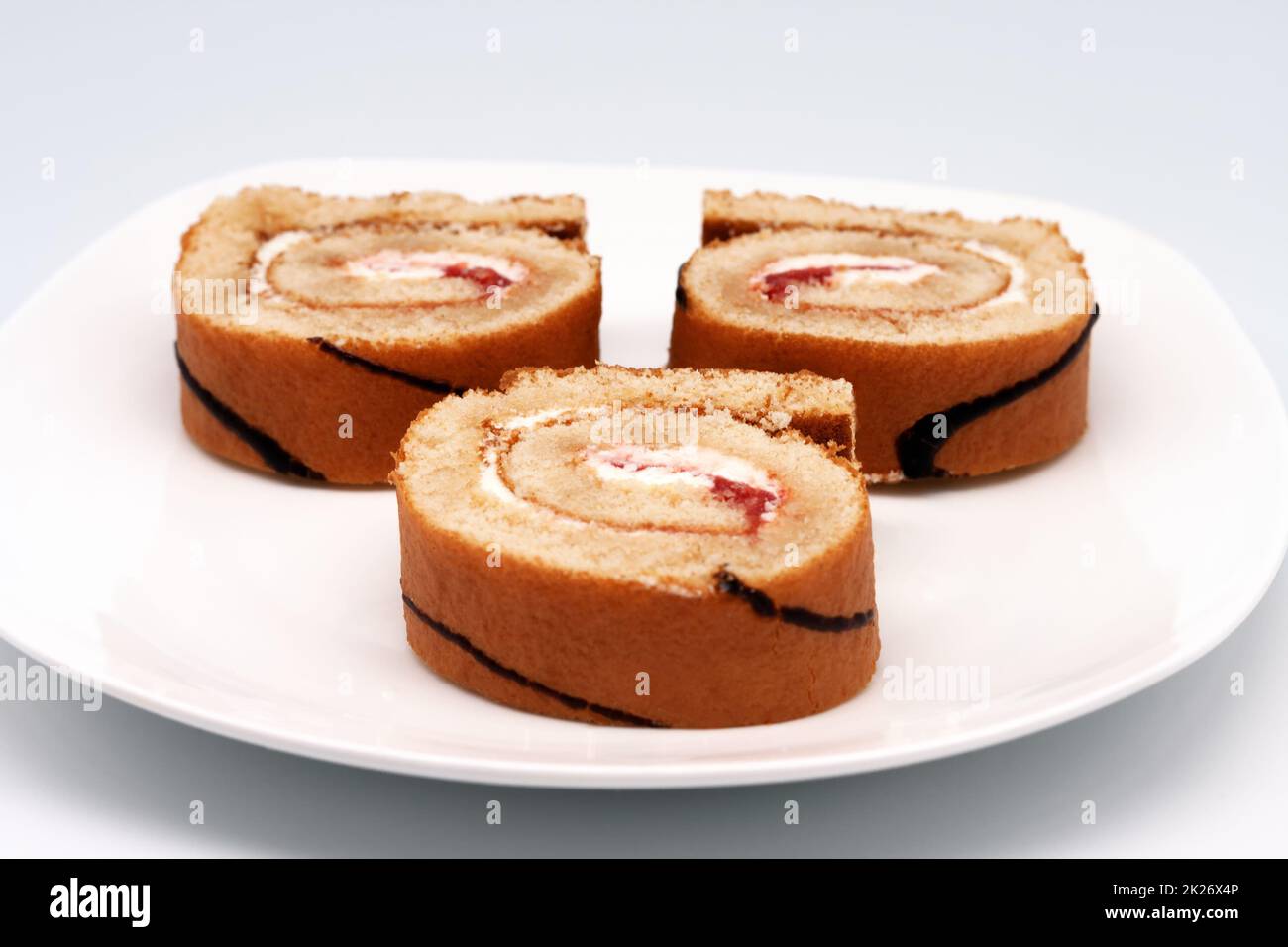 Sliced roll on a plate. Stock Photo