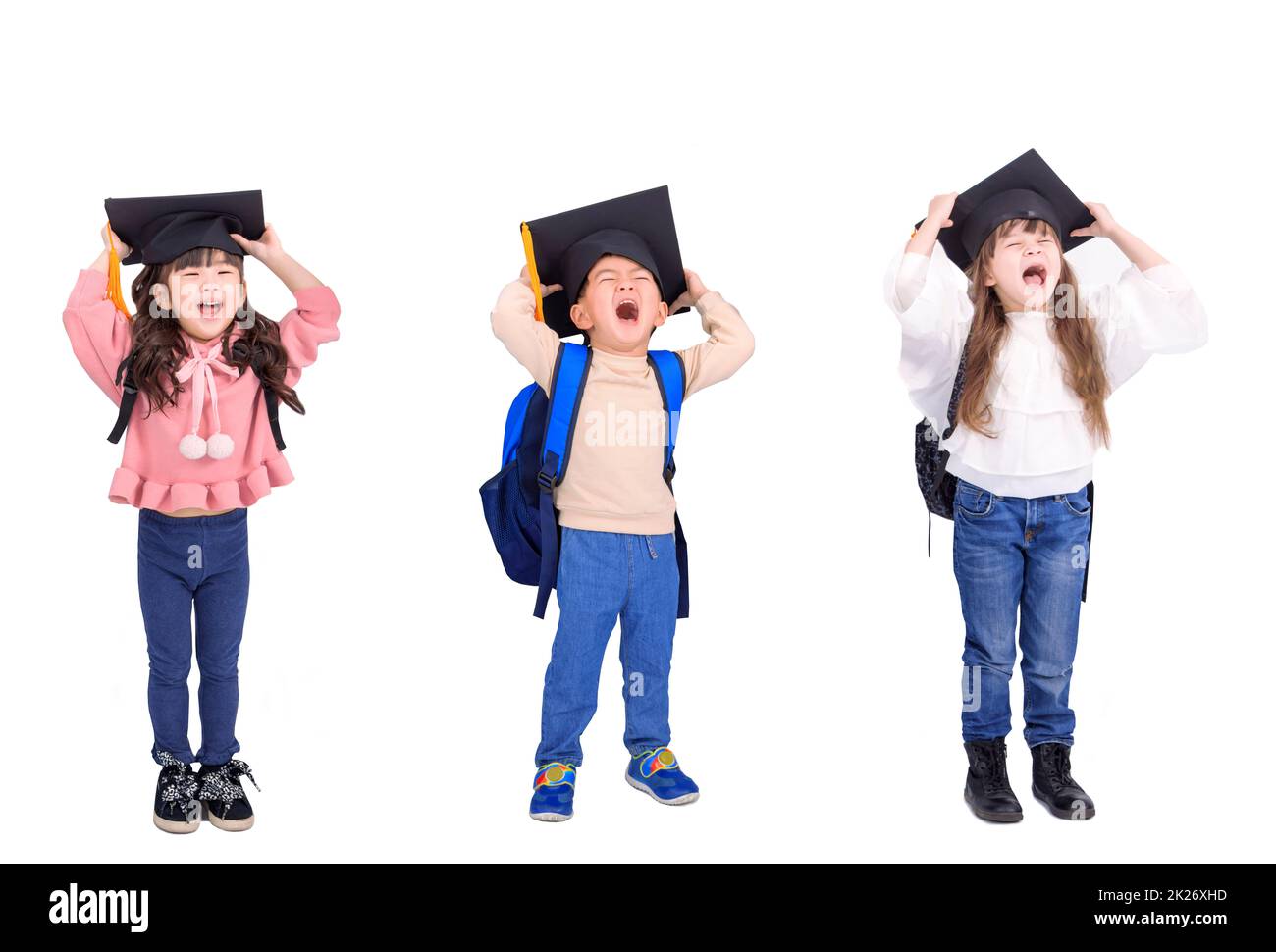 Happy excited kids in graduation cap and shouting Stock Photo