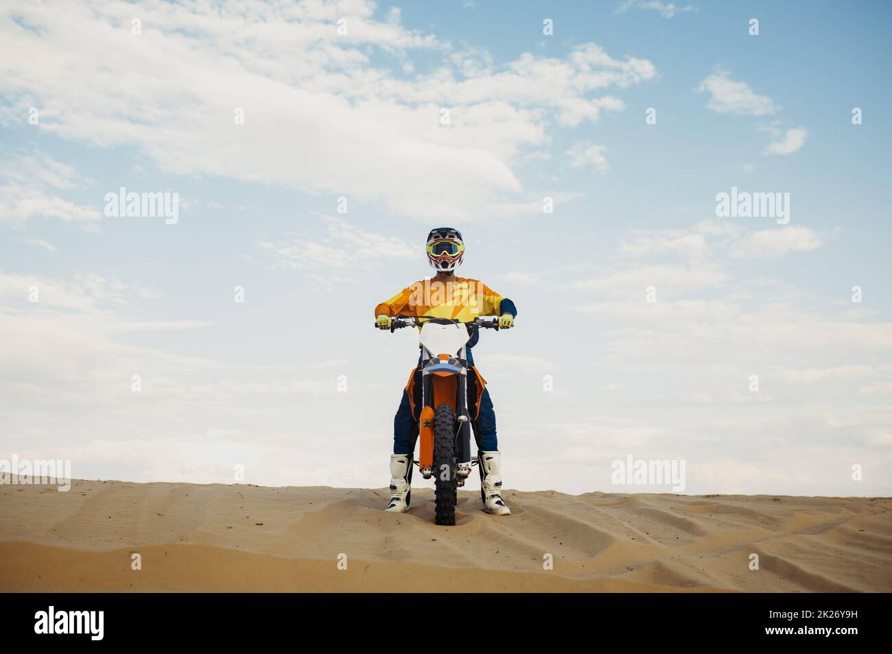 Motorcross rider with raised hand front view Stock Photo