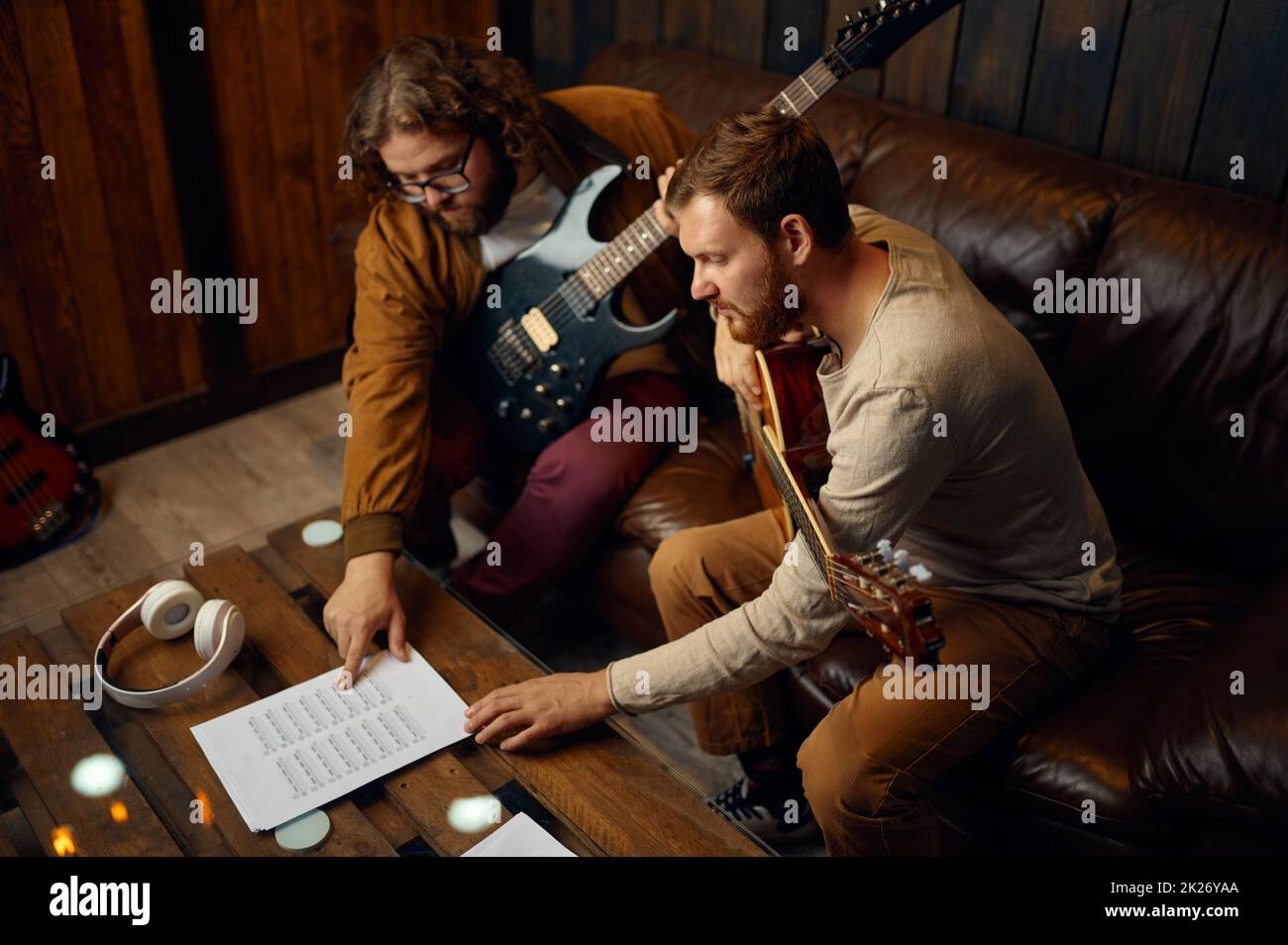 Instructor teaching man play guitar at home Stock Photo - Alamy