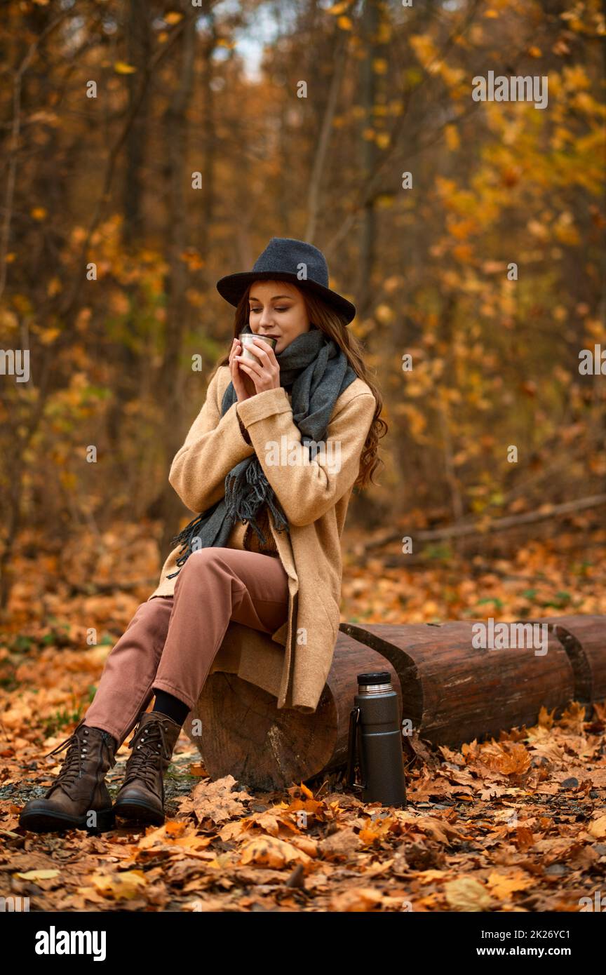 Stylish woman spend time on autumn nature Stock Photo