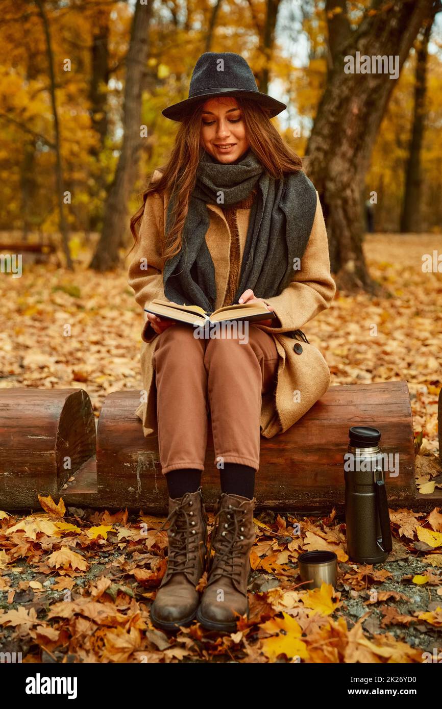 Woman rest reading book in autumn forest Stock Photo