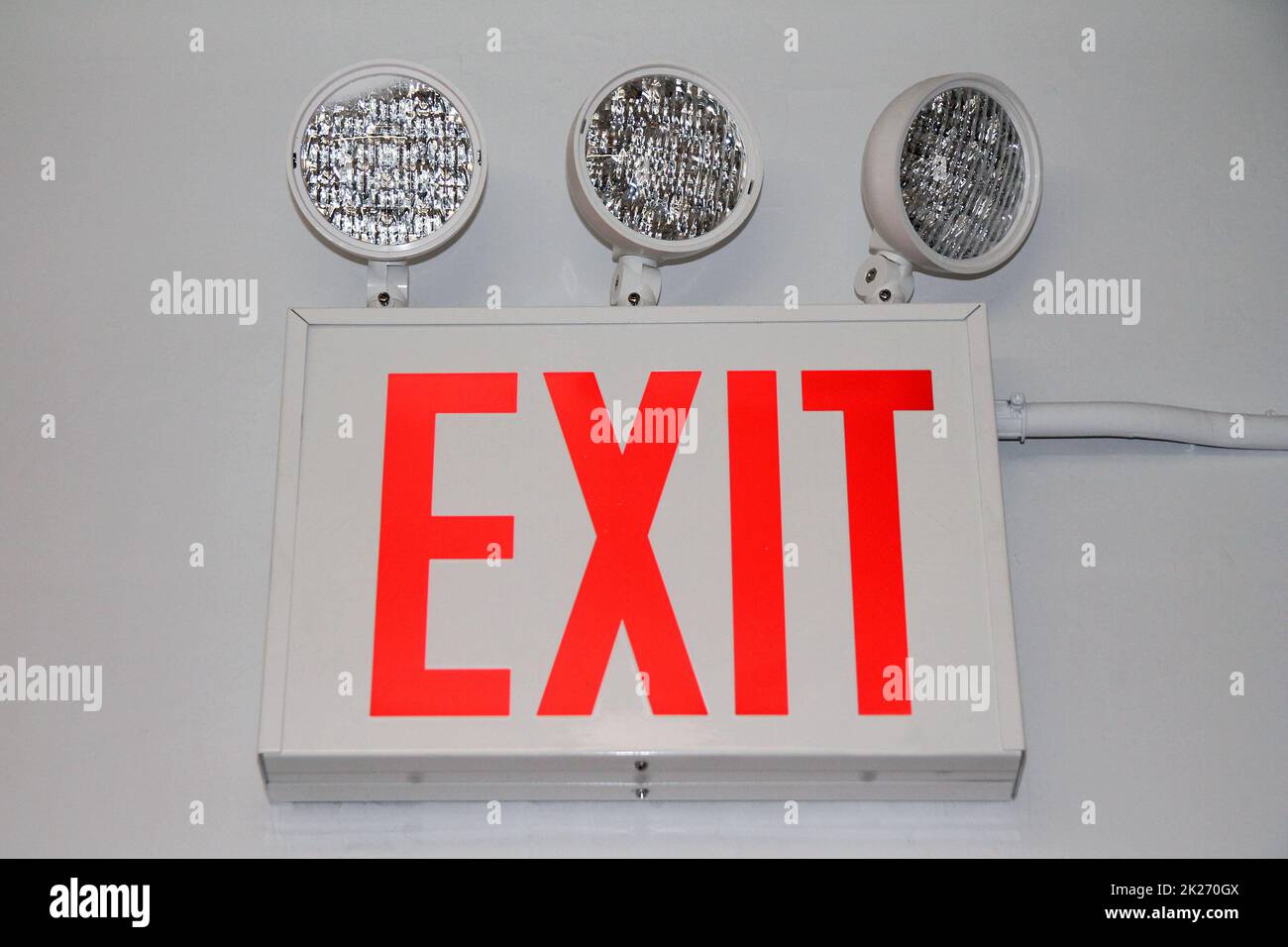 The flashing red security exit sign with three powerful lights Stock