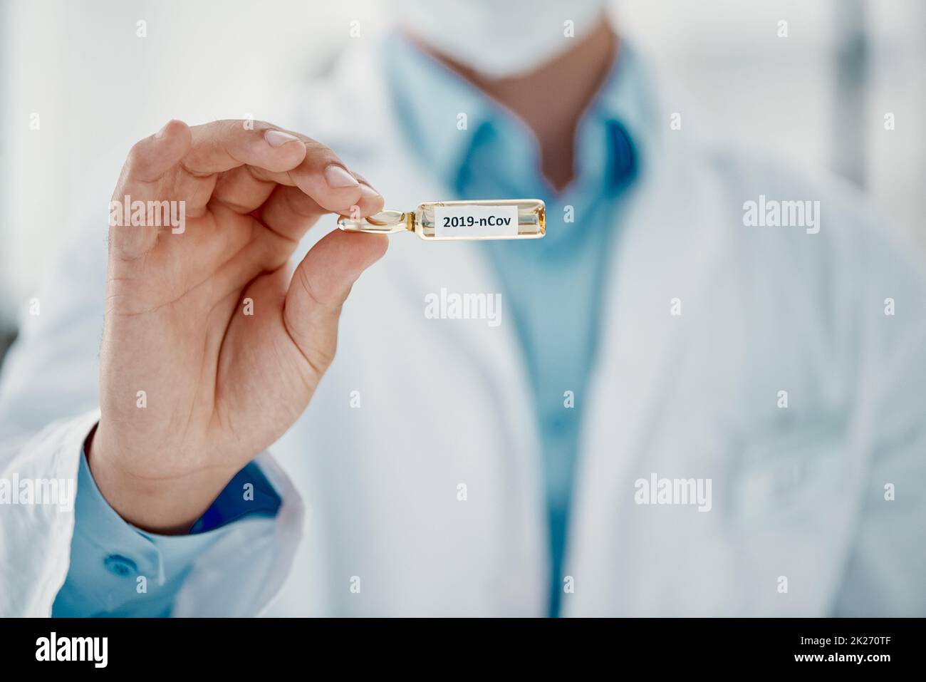 It's finally here. Cropped shot of a scientist holding an ampoule with 2019-nCov on it. Stock Photo