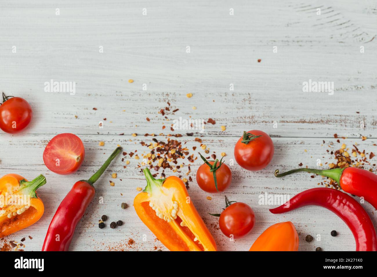 Assorted peppers, cherry tomatoes and spices on light background Stock Photo