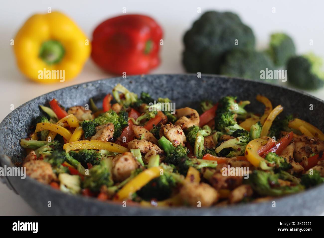 Stir fried vegetables with chicken in frying pan. Air fried chicken cubes tossed with sauteed