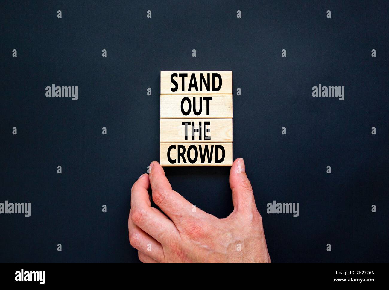 Stand out the crowd symbol. Concept words Stand out the crowd on wooden
