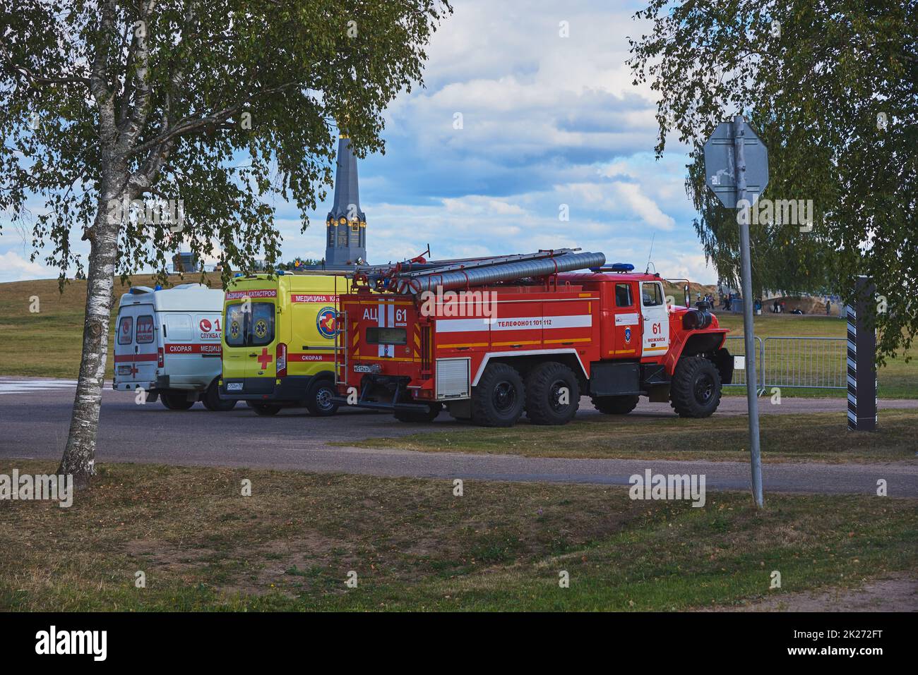 Three official cars, an ambulance, an intensive care unit and a fire department, are standing on the field in case of an accident. Stock Photo