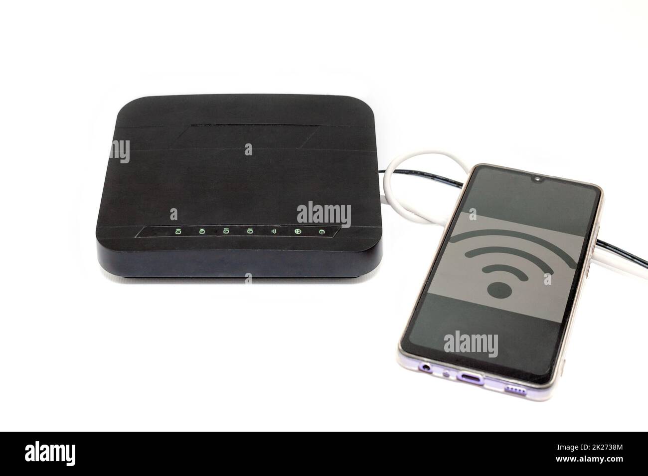 Black wifi router and mobile phone with wifi sign on the screen