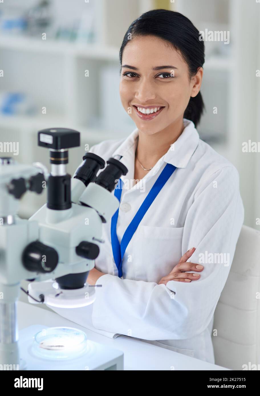 Medical research that makes a difference. Portrait of a young scientist using a microscope in a laboratory. Stock Photo