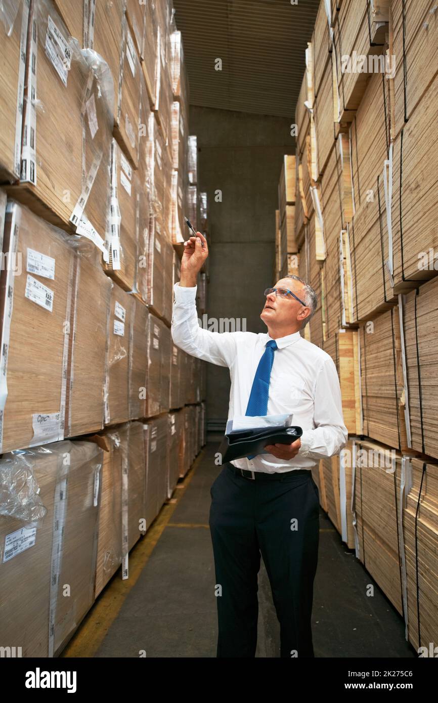 Getting the job done is vital. A manager standing in an aisle in a