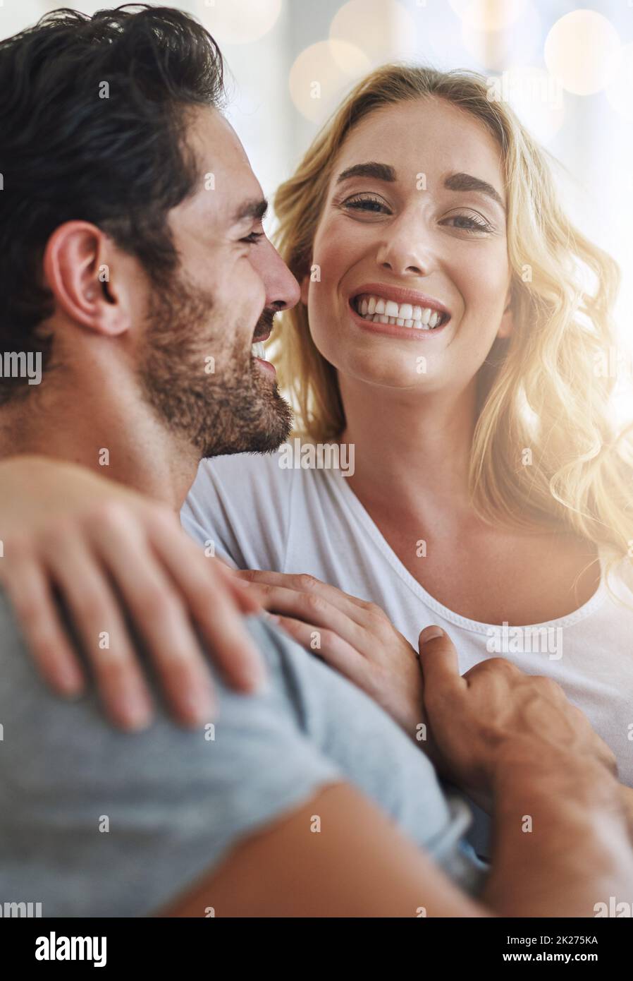 My hubby makes me so happy. Shot of a young couple relaxing at home. Stock Photo