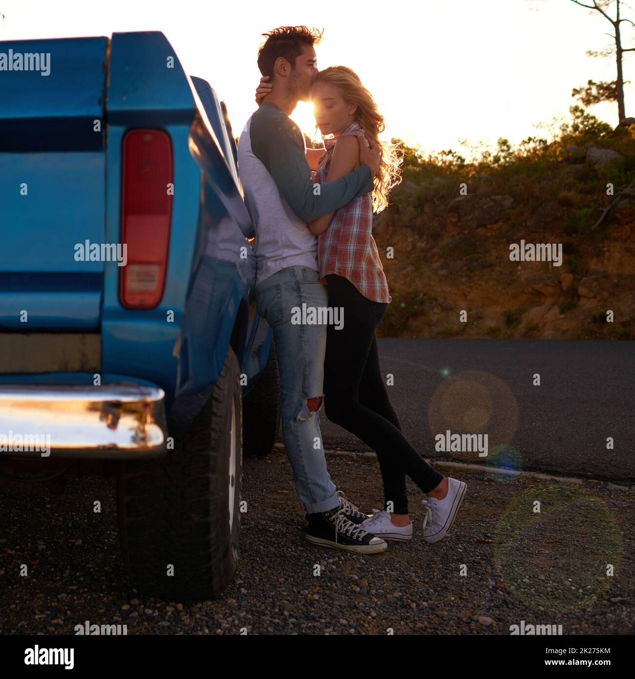 Off road romance. Shot of an affectionate young couple on a roadtrip. Stock Photo