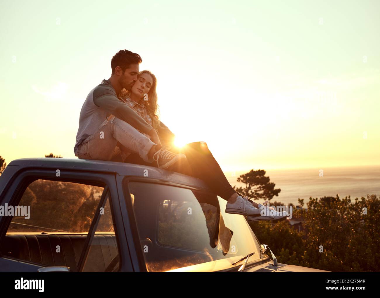 Romance on the road. Shot of an affectionate young couple enjoying a roadtrip together. Stock Photo