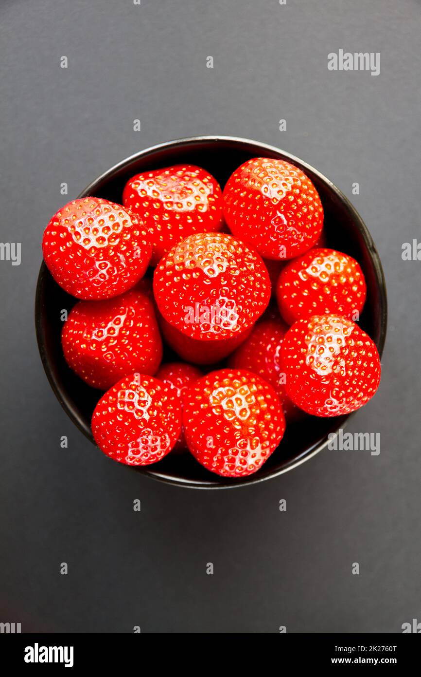 Strawberries in a bowl. Black background Stock Photo - Alamy