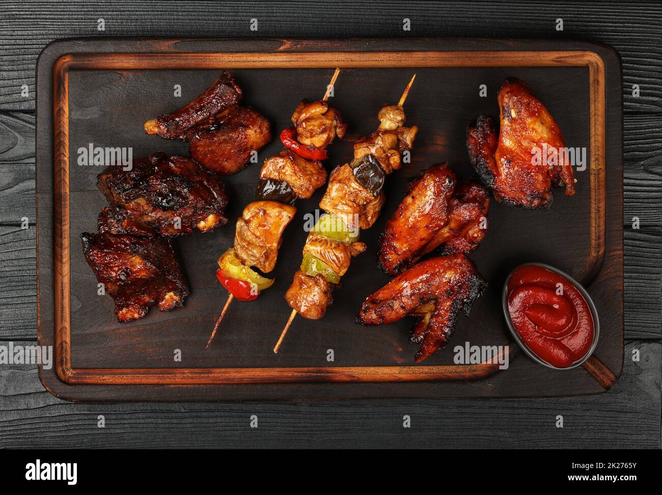 Mixed barbecue of chicken wings and beef ribs Stock Photo