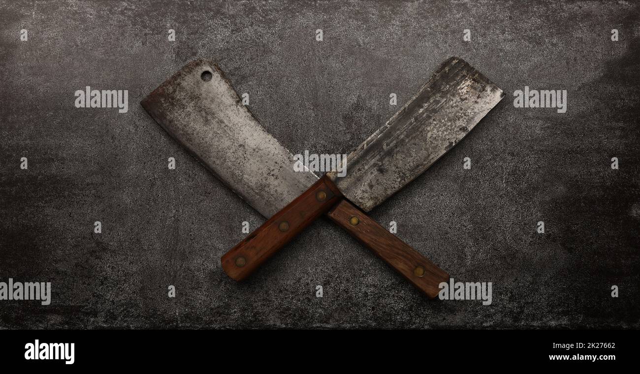 Two crossed vintage meat cleavers on table Stock Photo Alamy