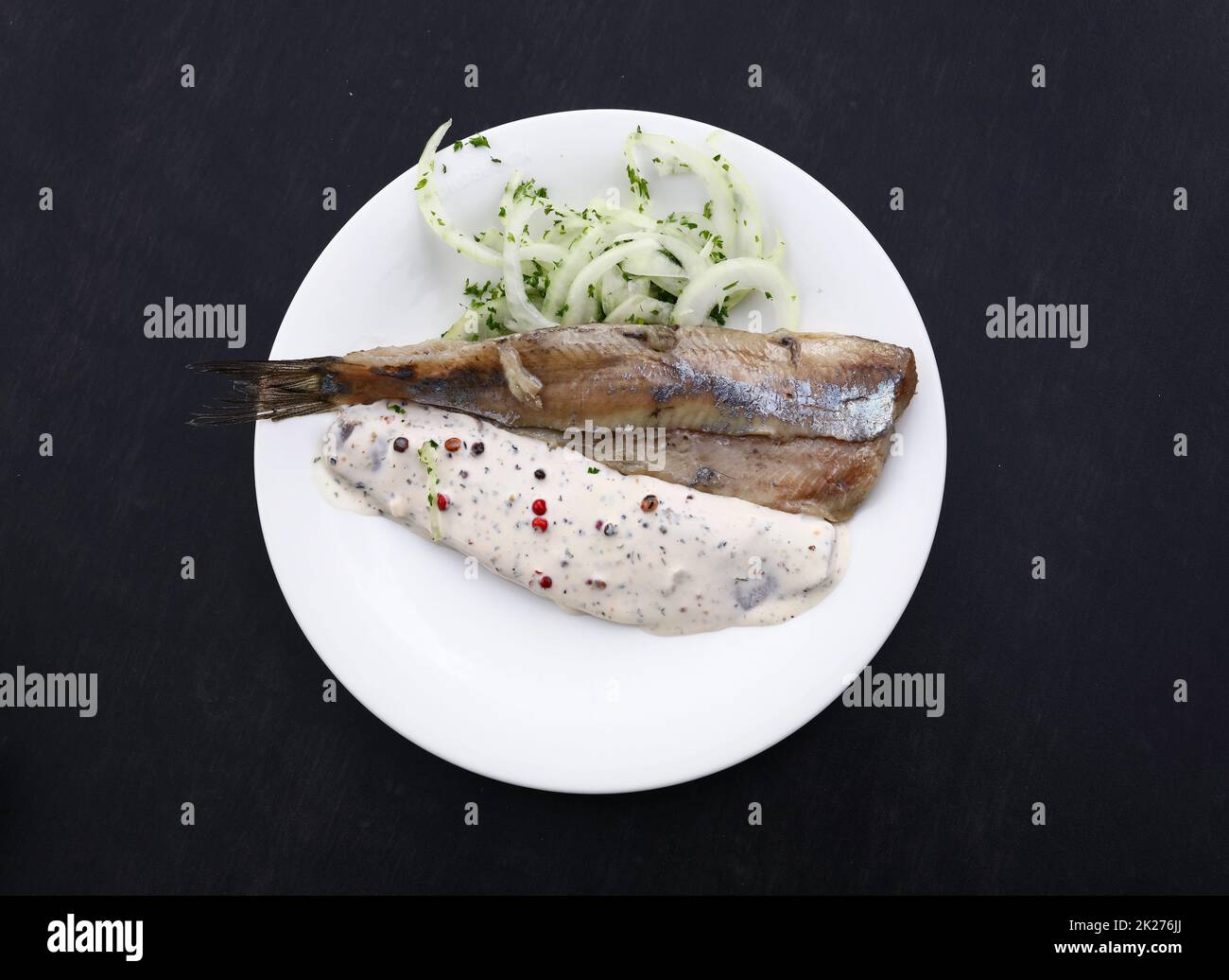 Portion of salted herring fish filets with onions Stock Photo