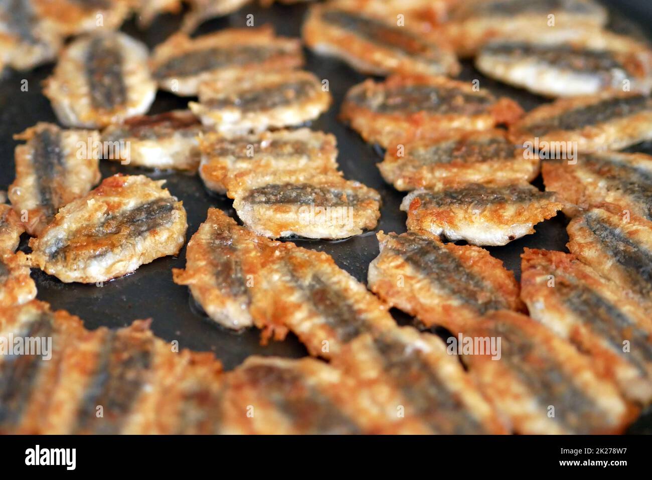 Anchovy is fried in a pan, cooking Turkish style anchovy, fried fish