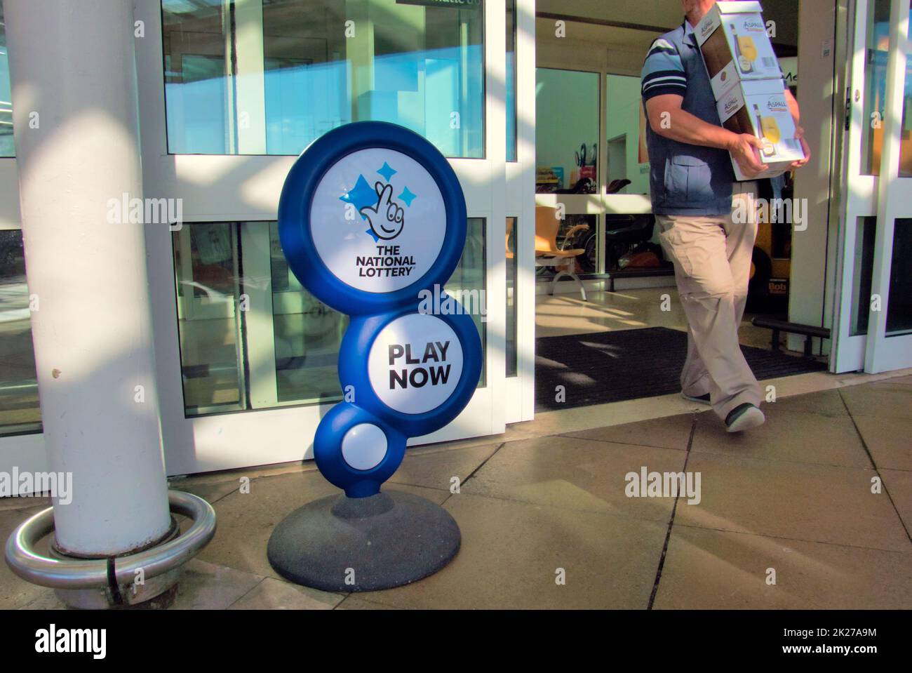 The national lottery advertising display stand play now in Glasgow, Scotland, UK Stock Photo