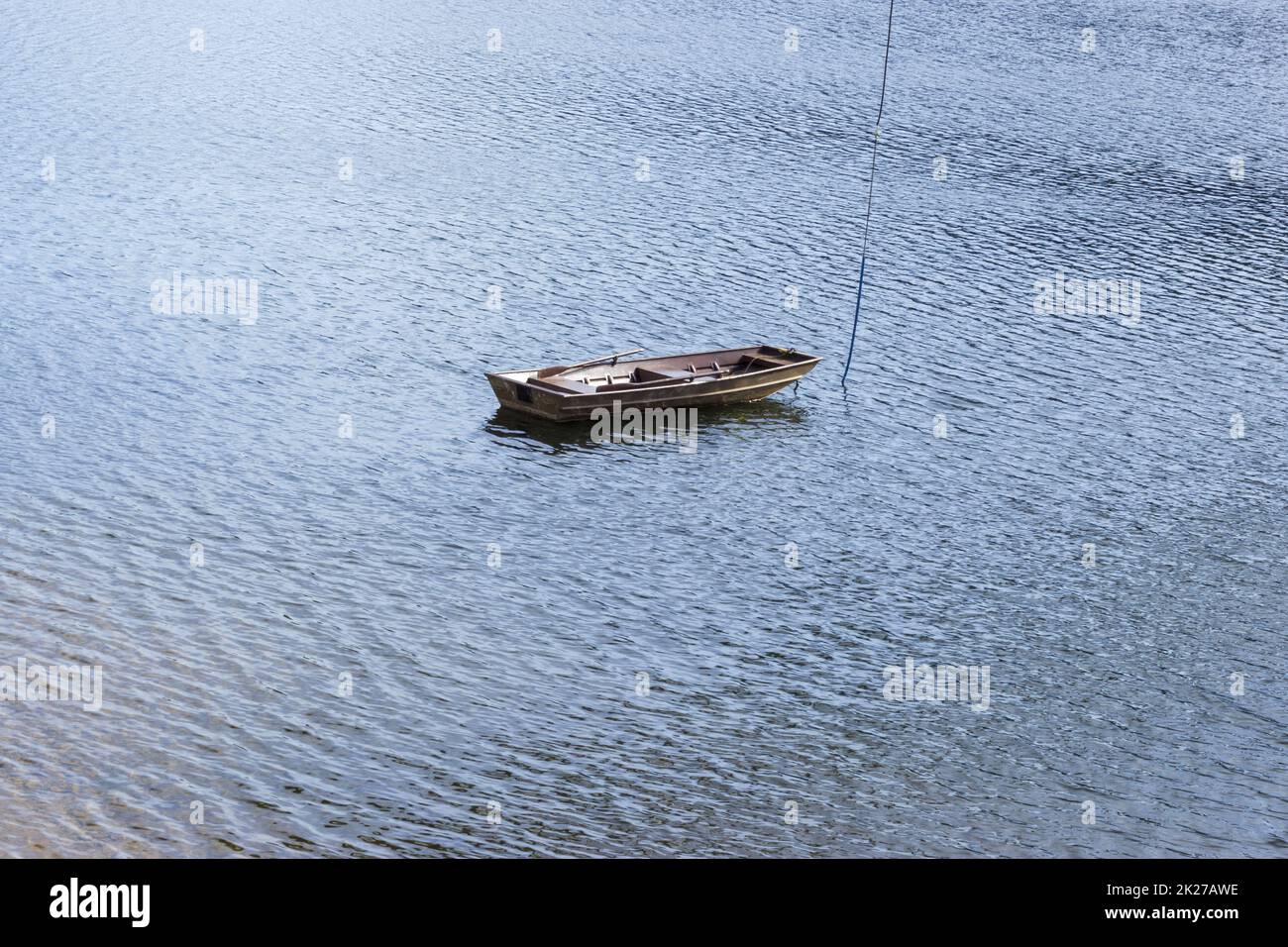 Little boat in the middle of the dam Stock Photo