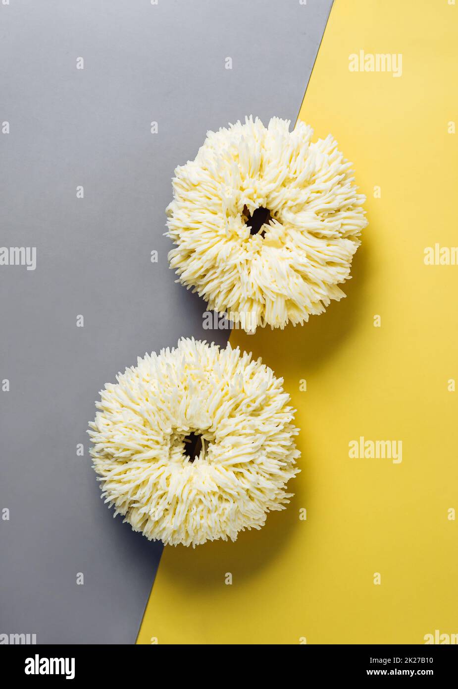Shag donuts on yellow background, copy space Stock Photo