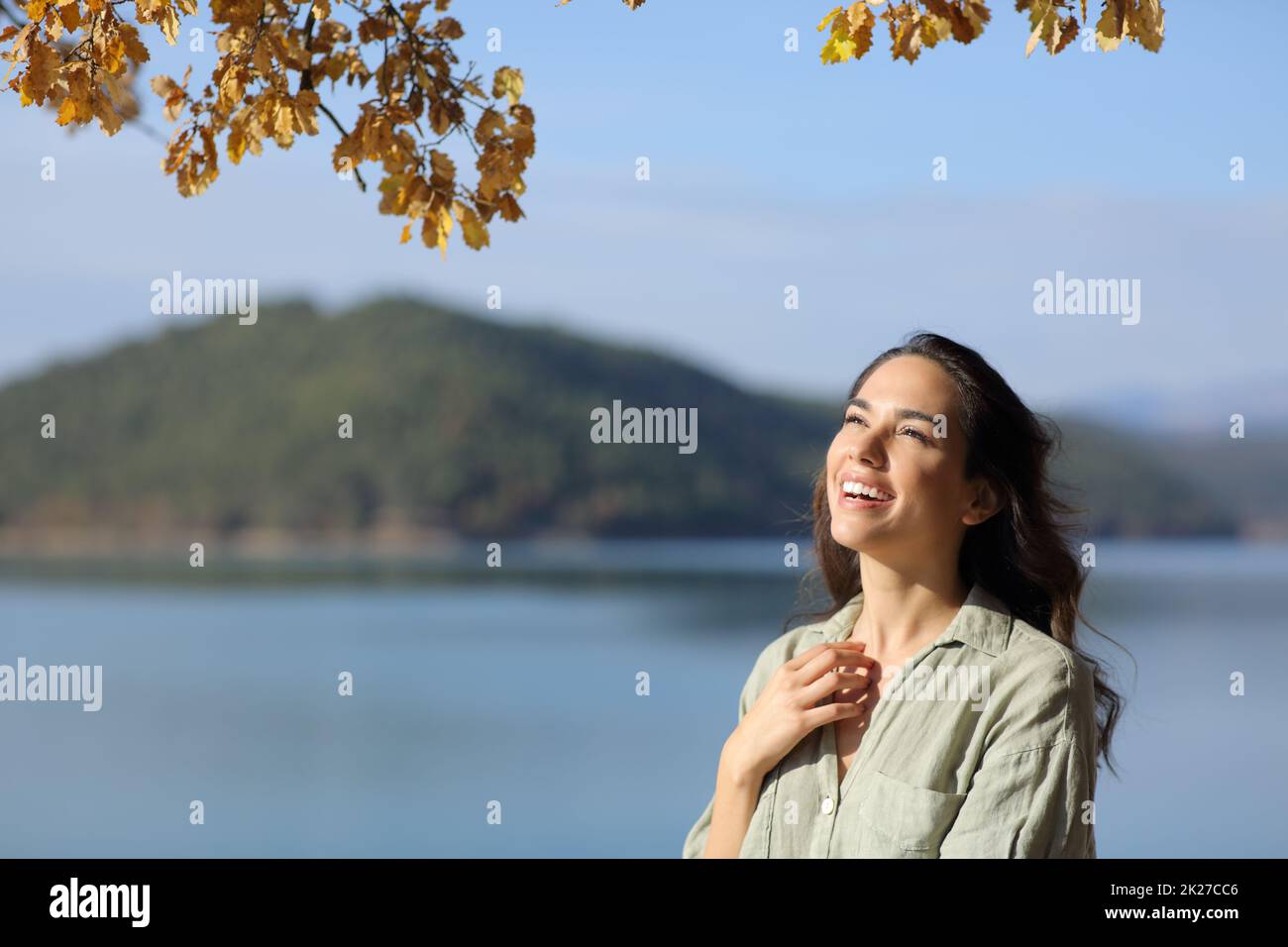 Amazed woman looking up in a lake on holiday Stock Photo