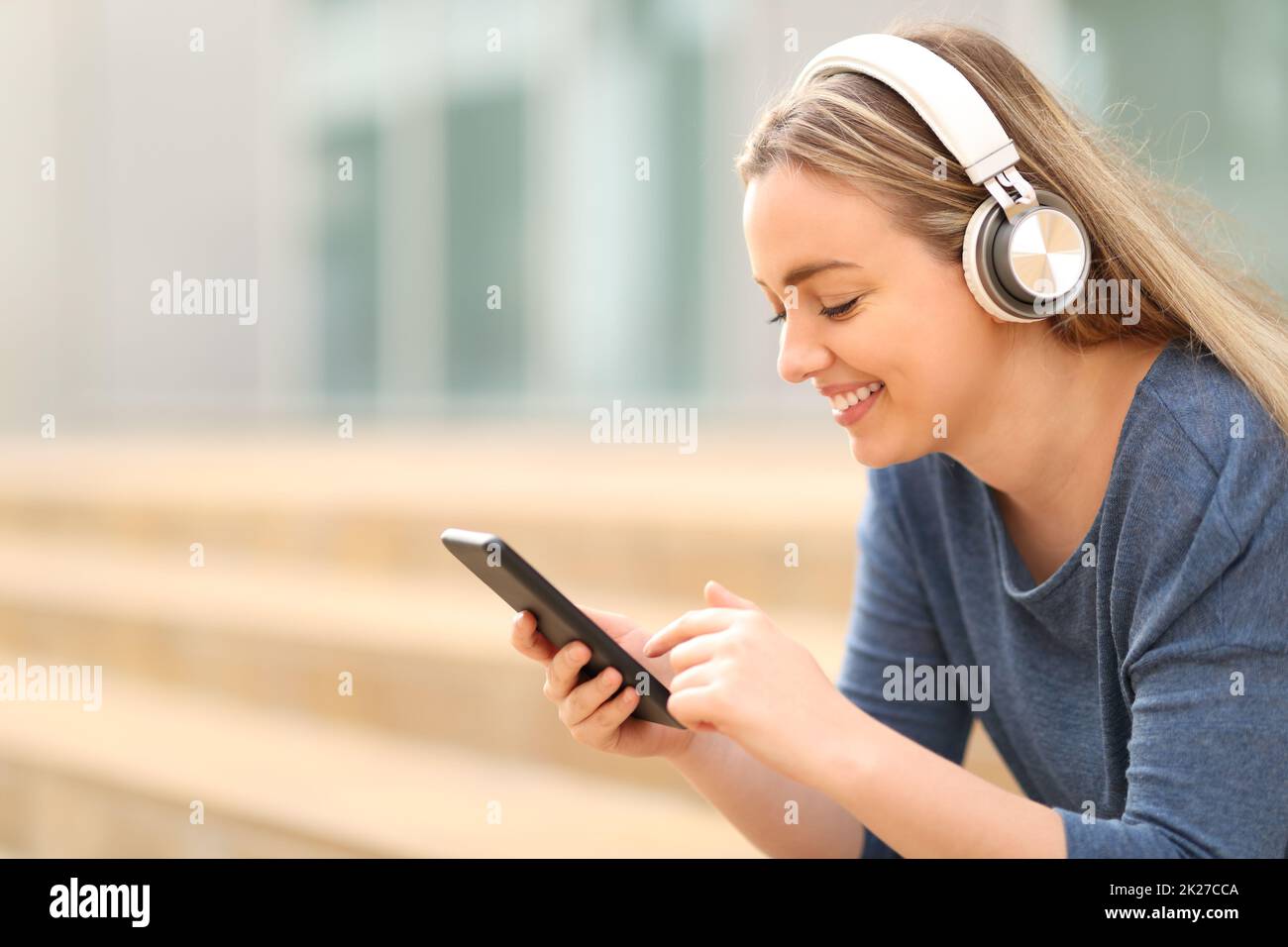 Happy teen listening to music in a campus Stock Photo Alamy