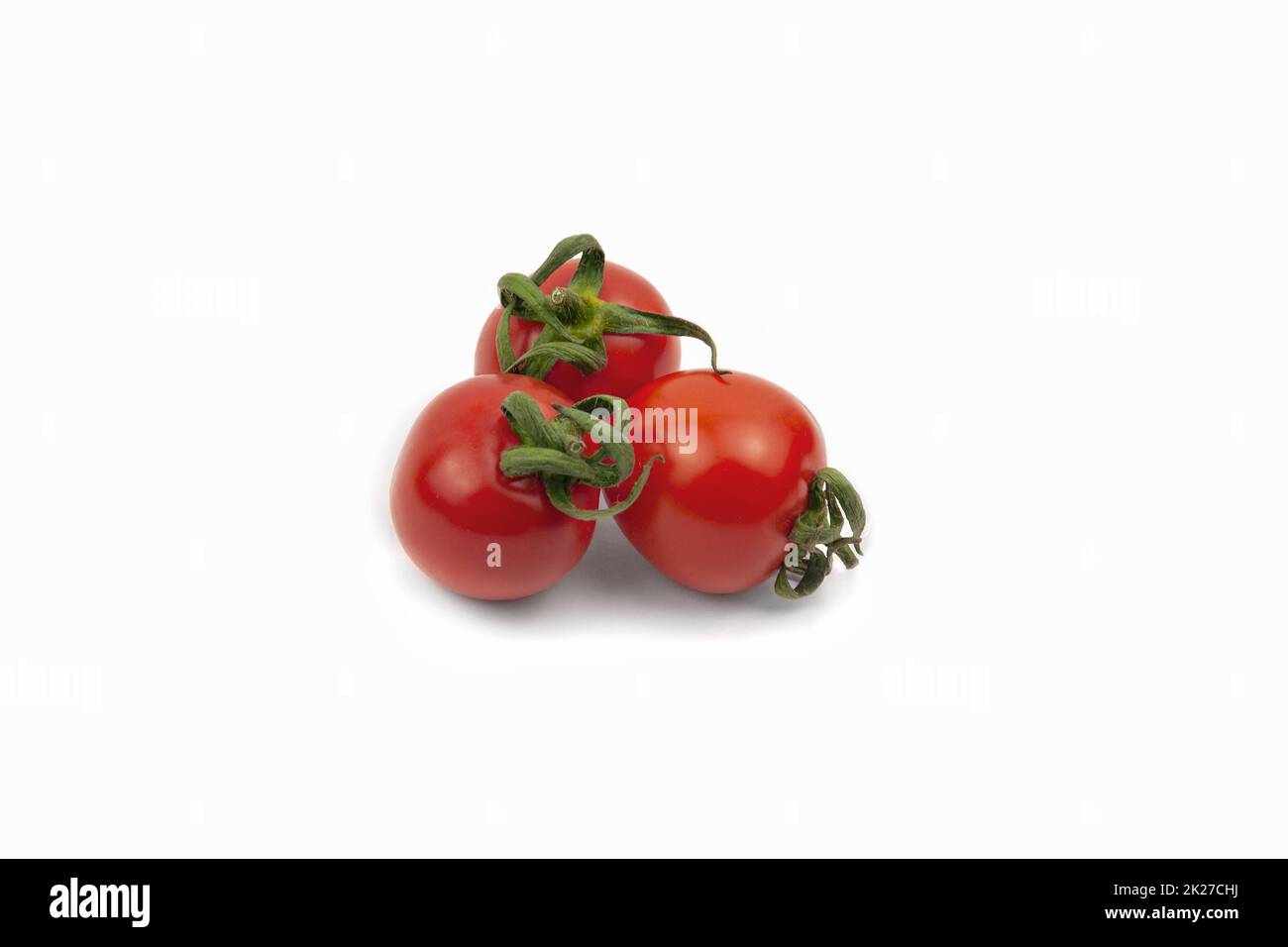 three red cherry tomato , datterino type isolated on white, copy space Stock Photo