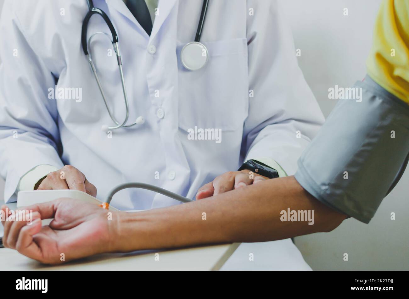 doctor measures the blood pressure of an elderly male patient Stock