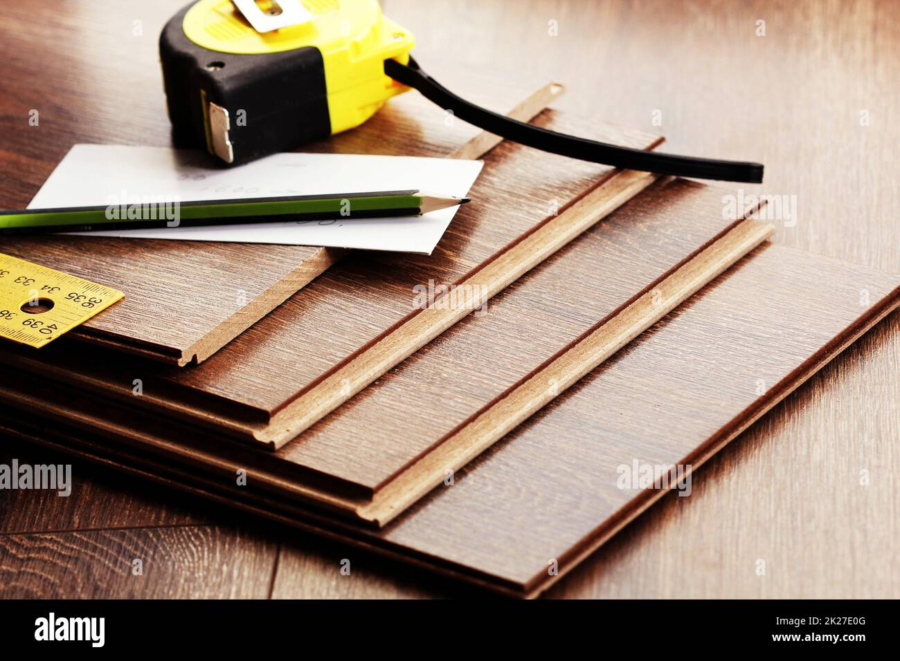 Laminate floor planks and tools on wooden background Stock Photo