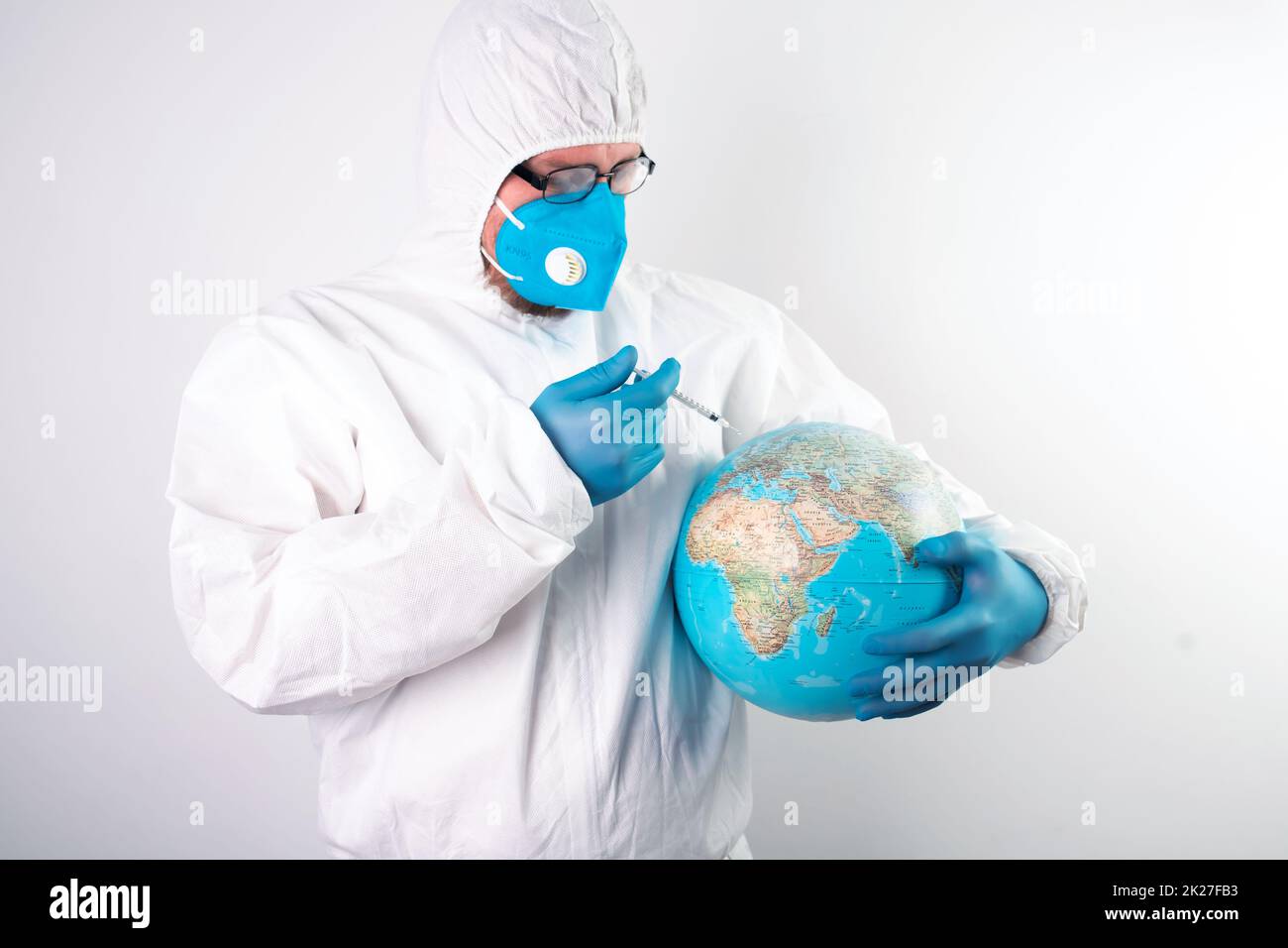 Doctor vaccinating the earth because of coronavirus Stock Photo