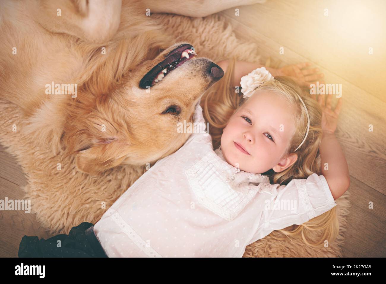 Hes my home dog. An adorable little girl with her dog at home. Stock Photo