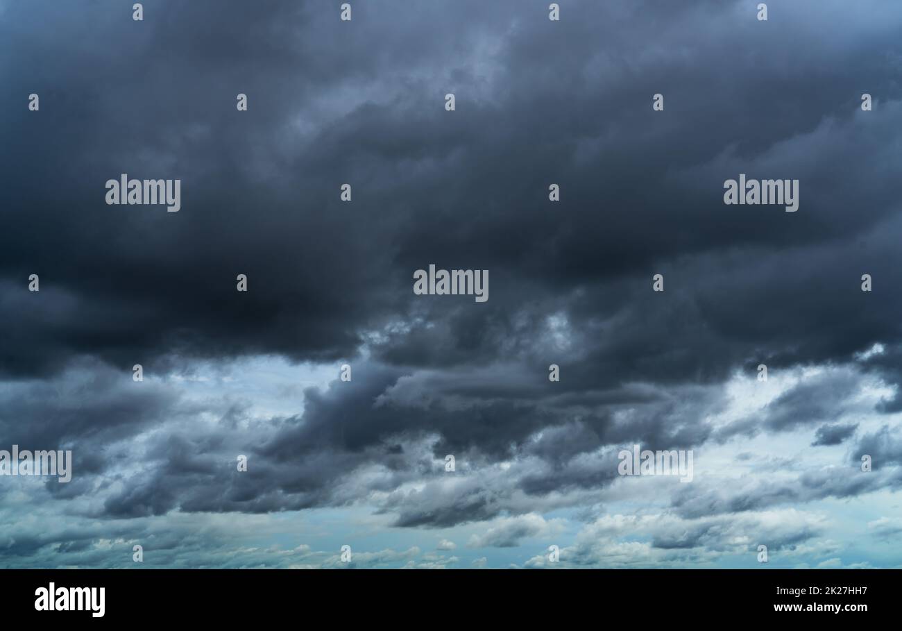 Overcast sky. Dramatic gray sky and dark clouds before rain in rainy season. Cloudy and moody sky. Storm sky. Gloomy and moody background. Overcast clouds. Sad, lonely, and death abstract background. Stock Photo
