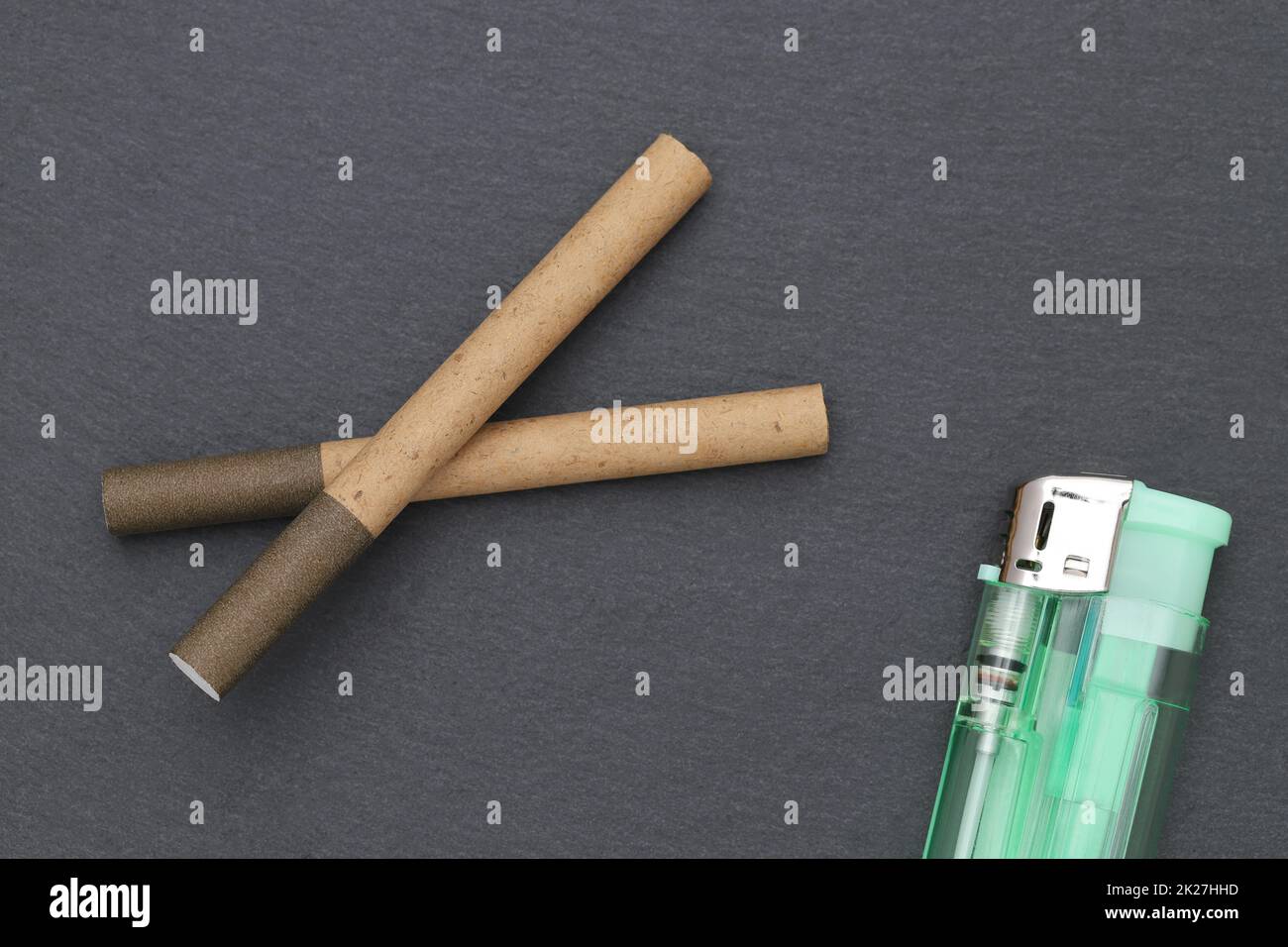 close up of cigarette with lighter on dark grey background Stock Photo