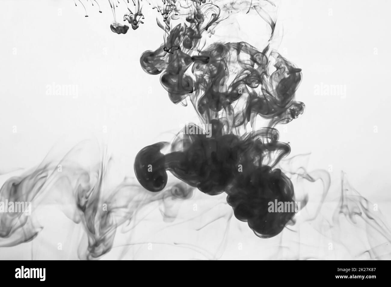 Ink in the water abstract background. splashes of paint swirling in liquid Stock Photo